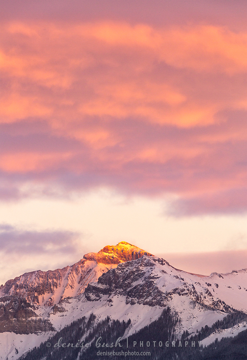 Redcliff Mountain near Ridgway Colorado lights up with the last warm light of the day.