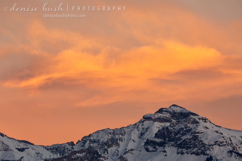 A beautiful sky appears at sunset to complement this wintry mountain peak.