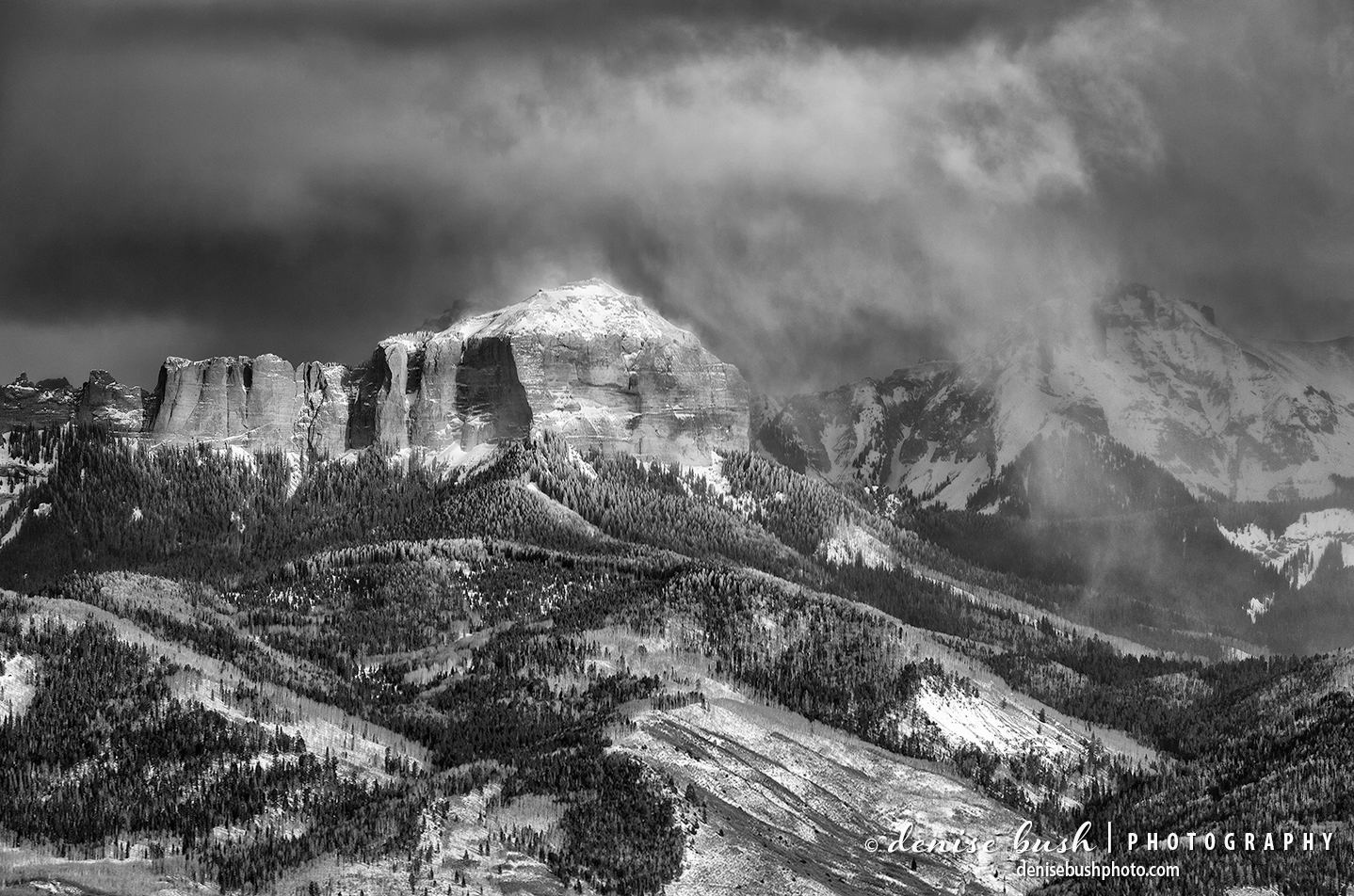 Courthouse mountain emerges from the clouds in winter.